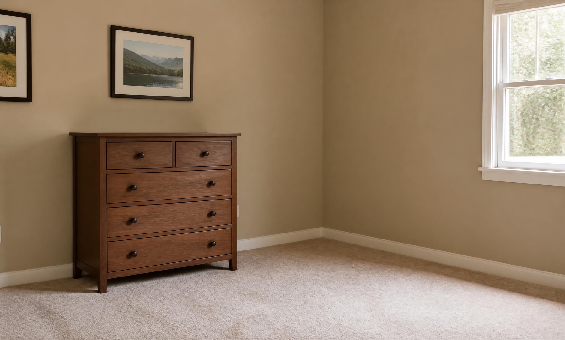 An empty spare room with a dresser and carpet, before the build
